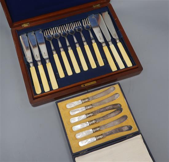 A case of twelve pairs of ivory handled silver plated dessert eaters and a cased set of six cake knives.